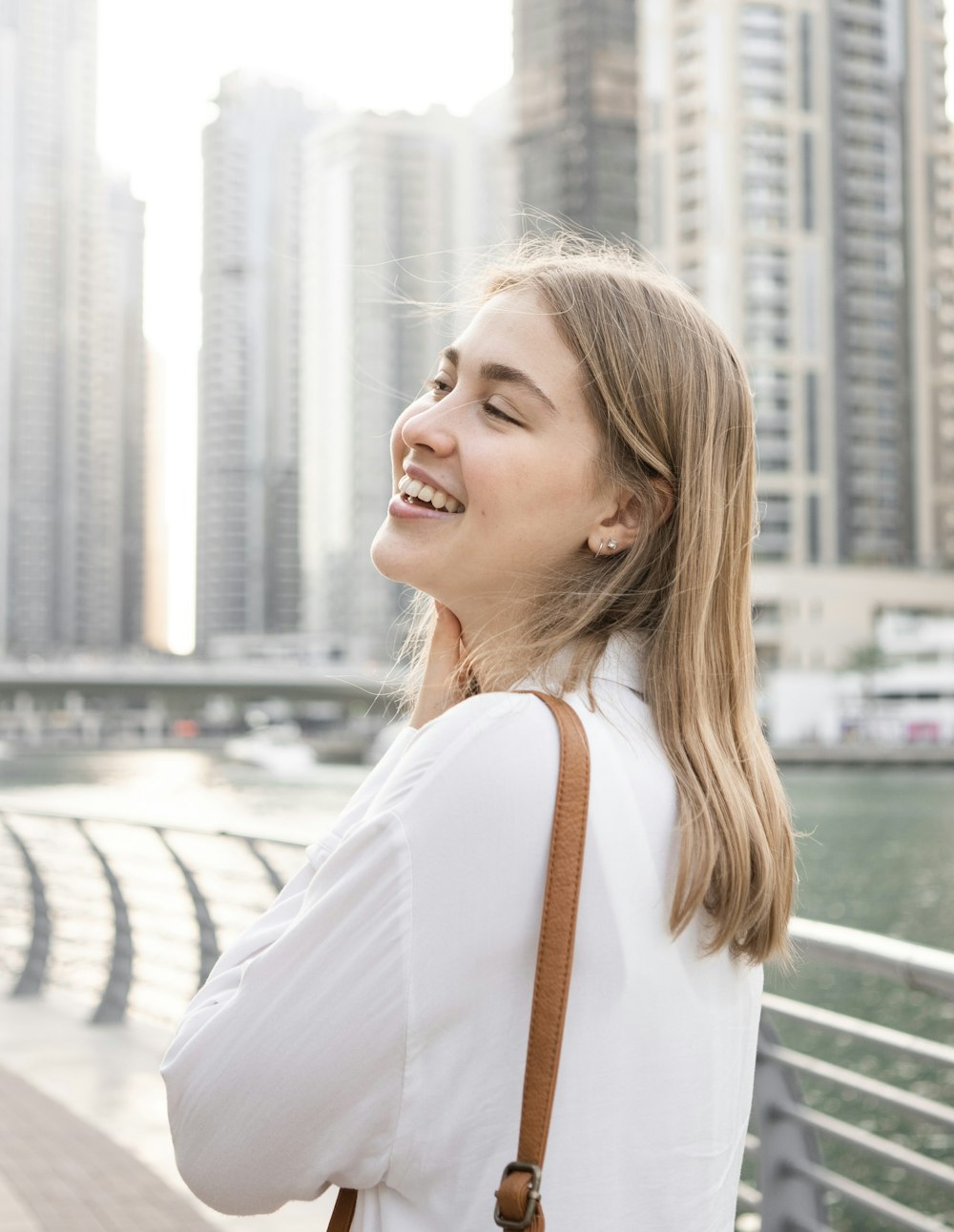 a woman standing on a bridge looking up at the sky