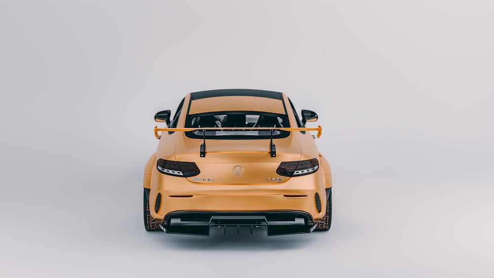 a yellow sports car parked in a studio