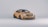 A sleek, modern sports car with a striking gold finish and aerodynamic design. The vehicle features a prominent front grille, sporty alloy wheels, and a rear spoiler for enhanced performance aesthetics.
