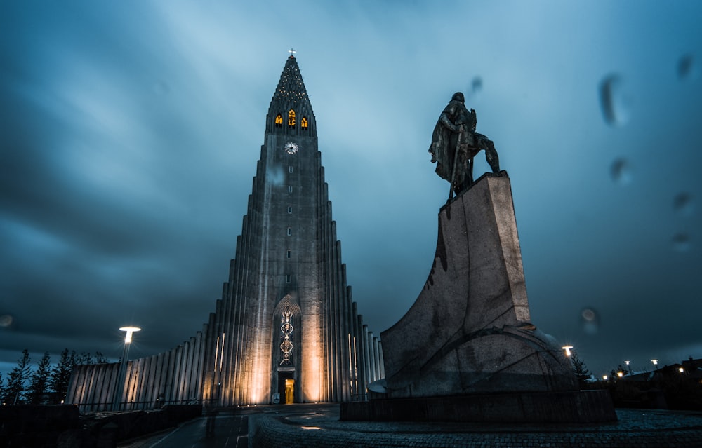 a very tall building with a statue in front of it