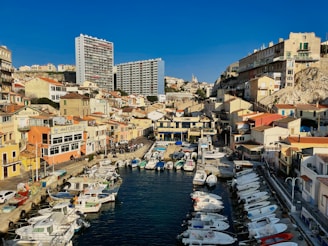 A sunny view of Ierapetra harbor with boats and scooters ready for rental.