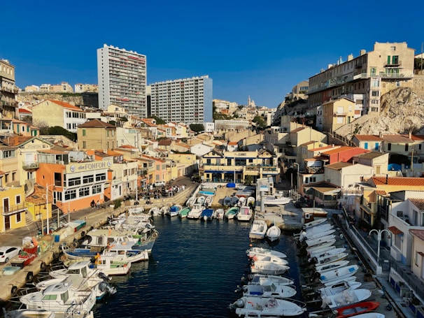 A sunny view of Ierapetra harbor with boats and scooters ready for rental.
