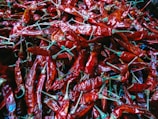 a pile of red peppers sitting on top of a table