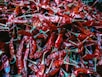a pile of red peppers sitting on top of a table