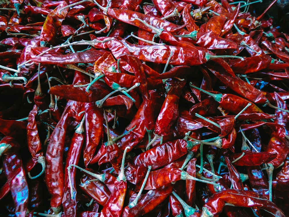 a pile of red peppers sitting on top of a table