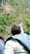 Instructor demonstrating rescue techniques on rocky landscape.