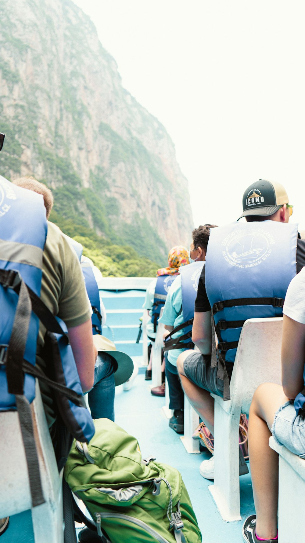 a group of people sitting on a boat in the water