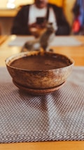 A close-up of a traditional ayahuasca brew in a rustic bowl.