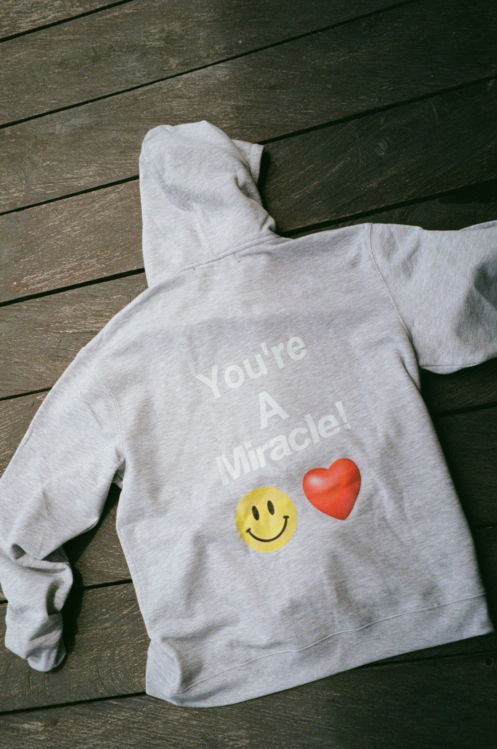 a child's hoodie with a smiley face on it