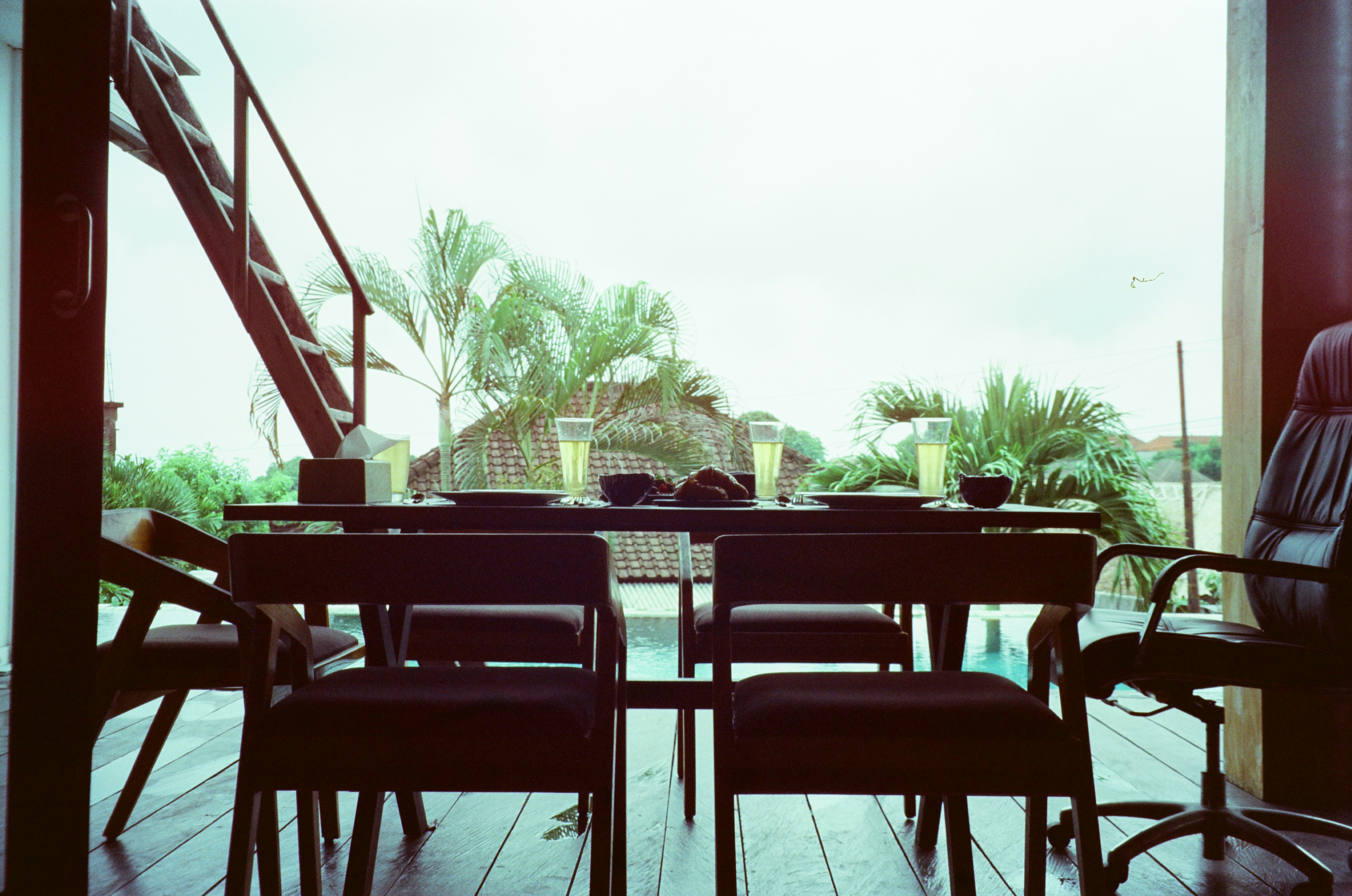 a dining room table with chairs and a view of a pool