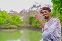 A joyful teenager enjoying a bright candy from Satva Sweets outdoors.