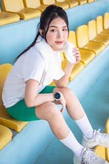 a woman sitting on a bench in a stadium