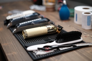 A barber's tools neatly arranged on a wooden table.