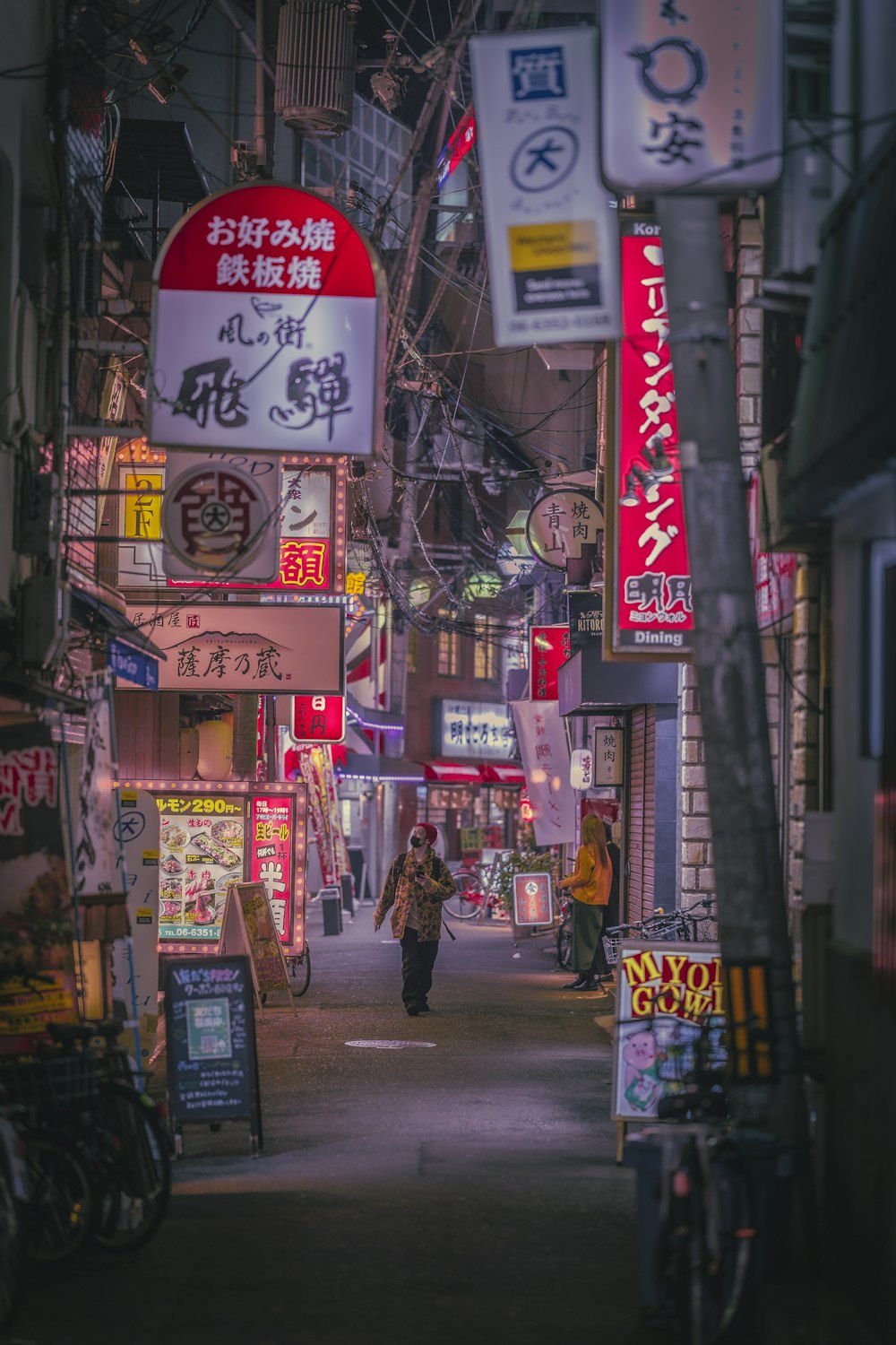 a person walking down a narrow alley way