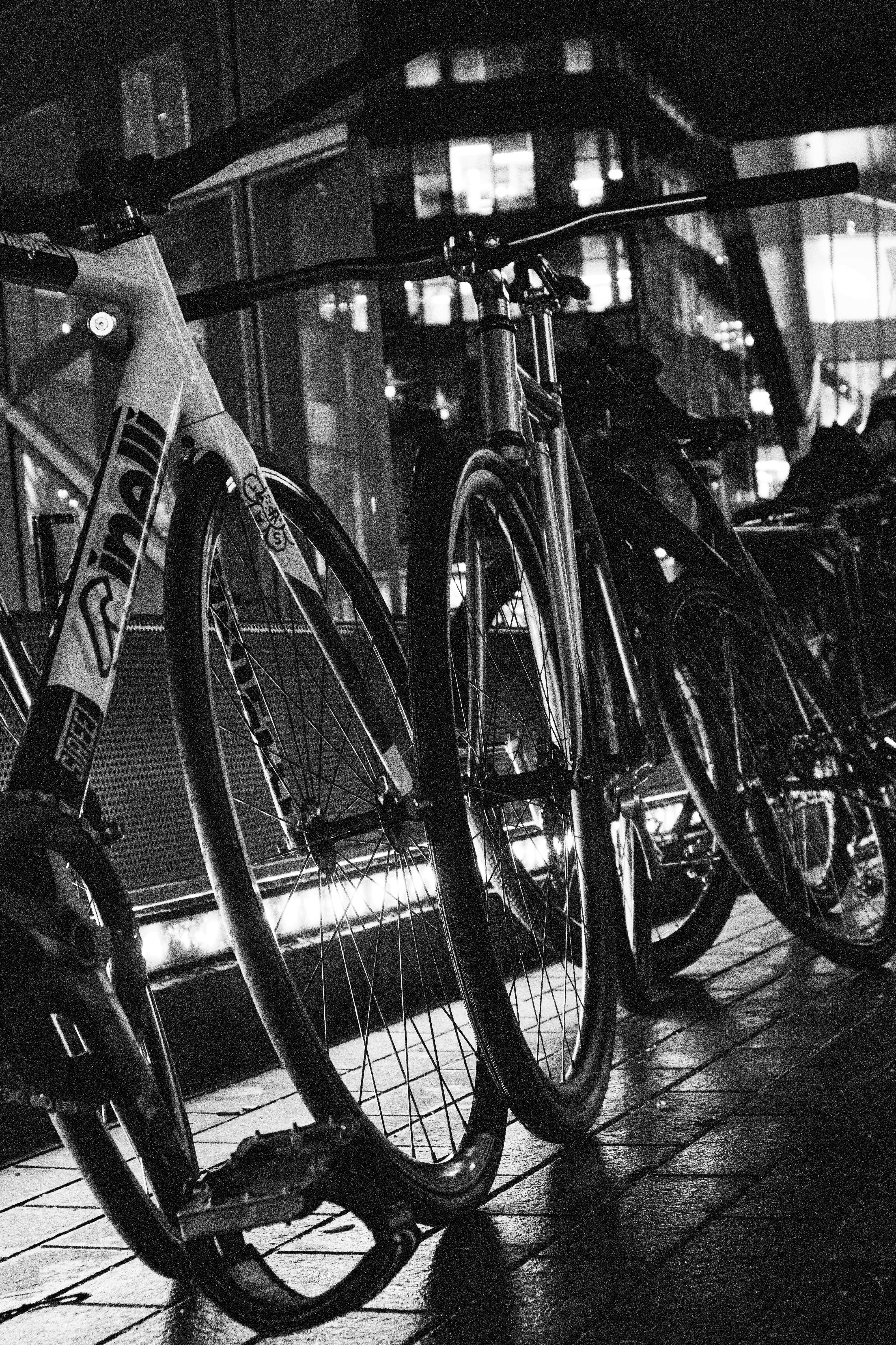a row of bikes parked next to each other on a sidewalk