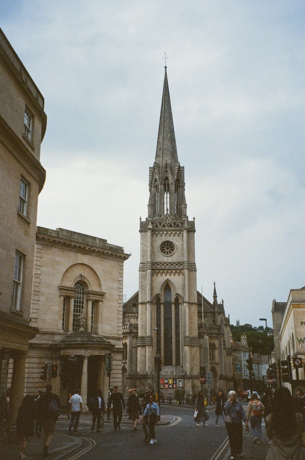 a group of people walking down a street in front of a church