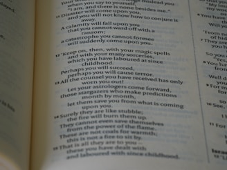 A close-up view of a page from a book with text printed in two columns. The text appears to be a section of literary or religious content with numbered verses, and some parts emphasize warnings and predictions.