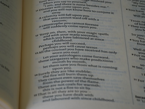 A close-up view of a page from a book with text printed in two columns. The text appears to be a section of literary or religious content with numbered verses, and some parts emphasize warnings and predictions.
