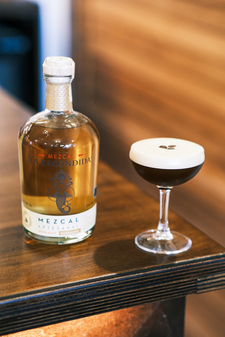 Dark spirit bottle in moody low light, photographed as for a ceremonial pour