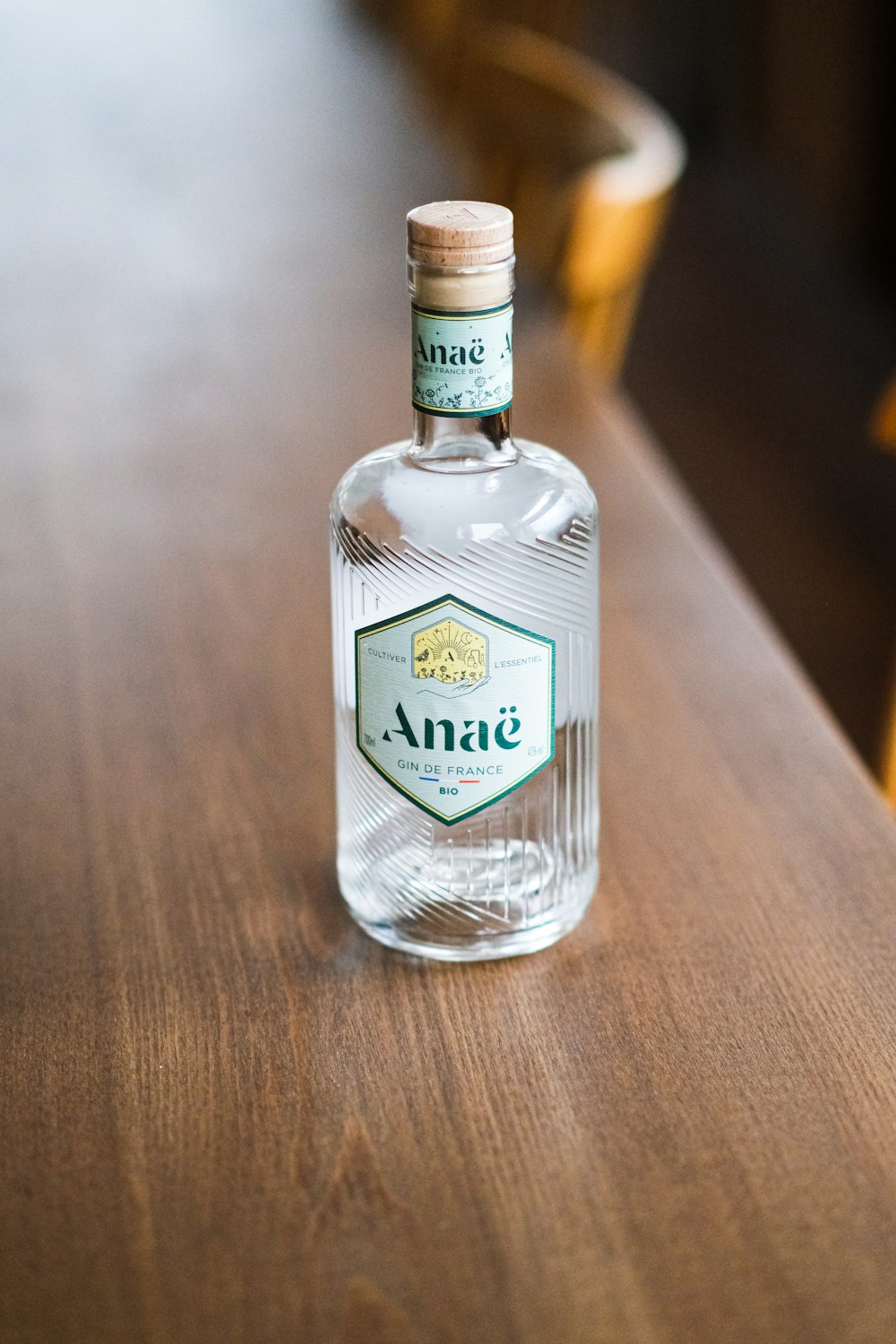 a bottle of anise on a wooden table