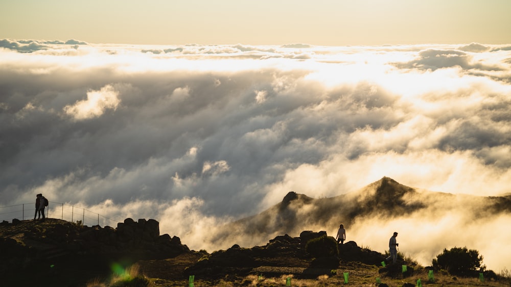 a group of people standing on top of a mountain