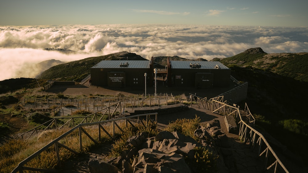 a building on top of a mountain surrounded by clouds