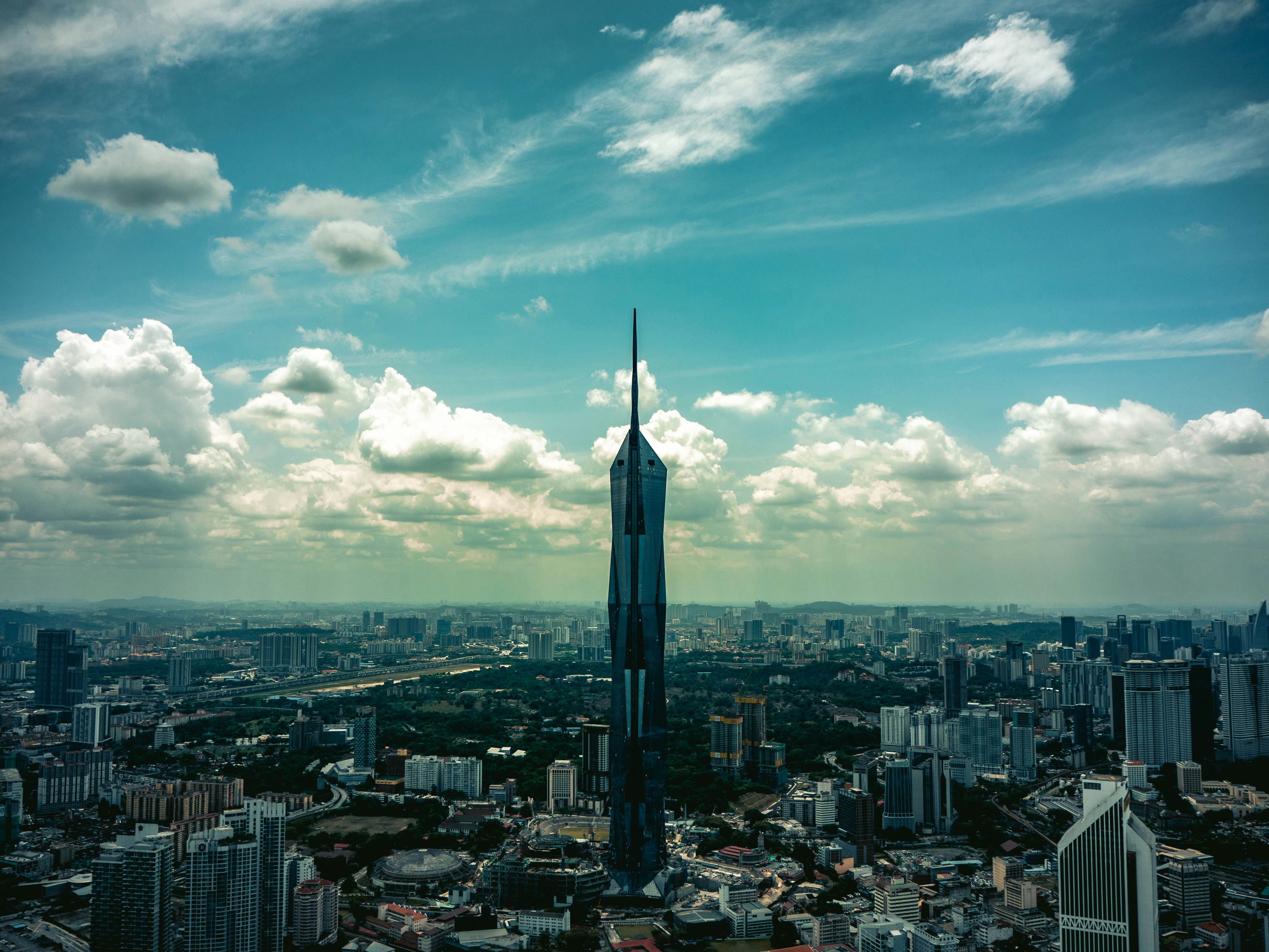 Image showcasing A very tall building towering over a city photo – Free Cityscape Image ...