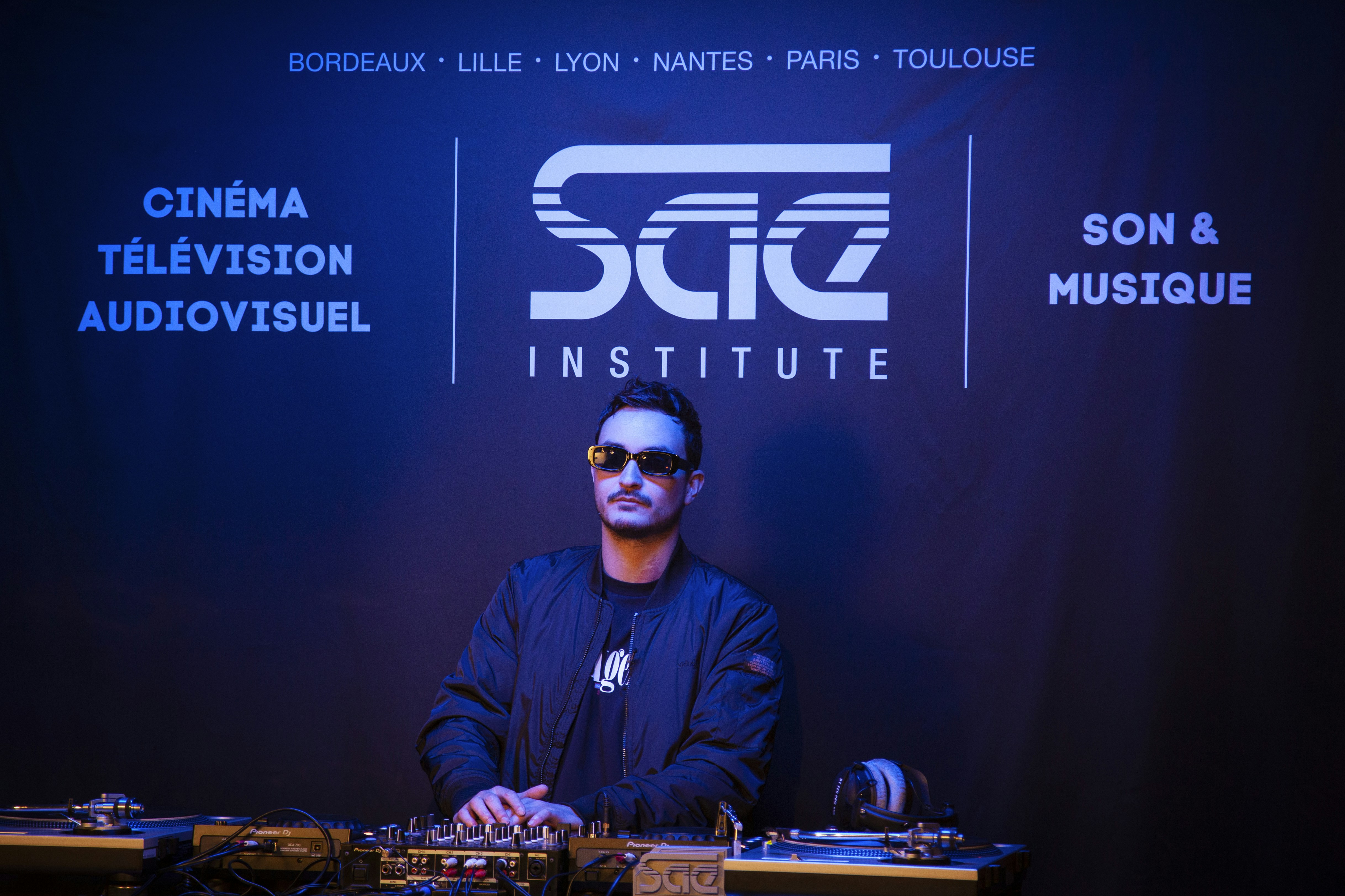 a man sitting at a table in front of a microphone