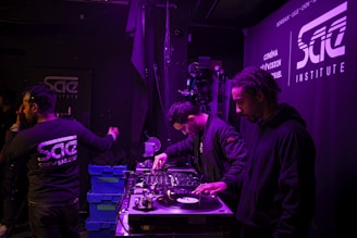 A group of aspiring DJs engaged in a hands-on workshop, collaborating and learning together.