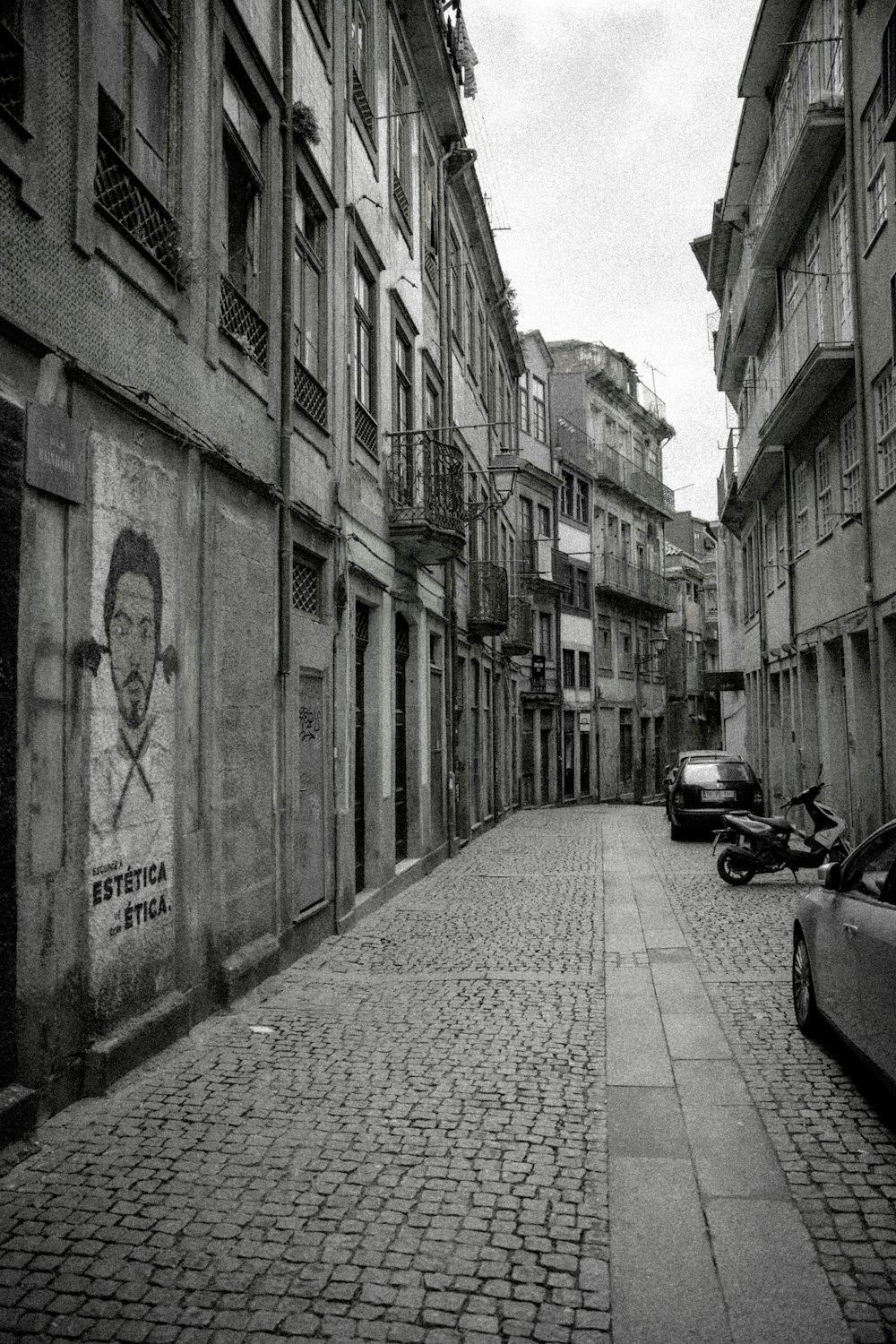 a black and white photo of a street in a city