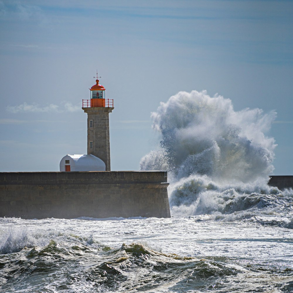 a lighthouse surrounded by waves in the ocean
