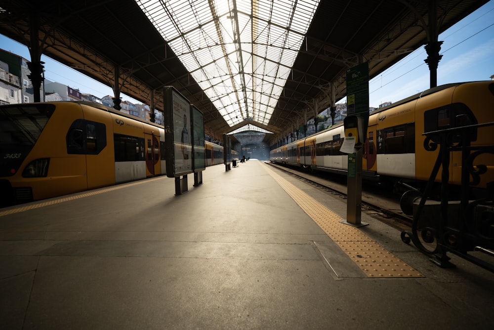 a train station with two trains parked next to each other