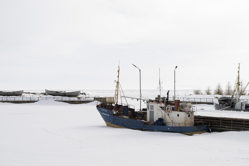 a boat sitting on top of snow covered ground