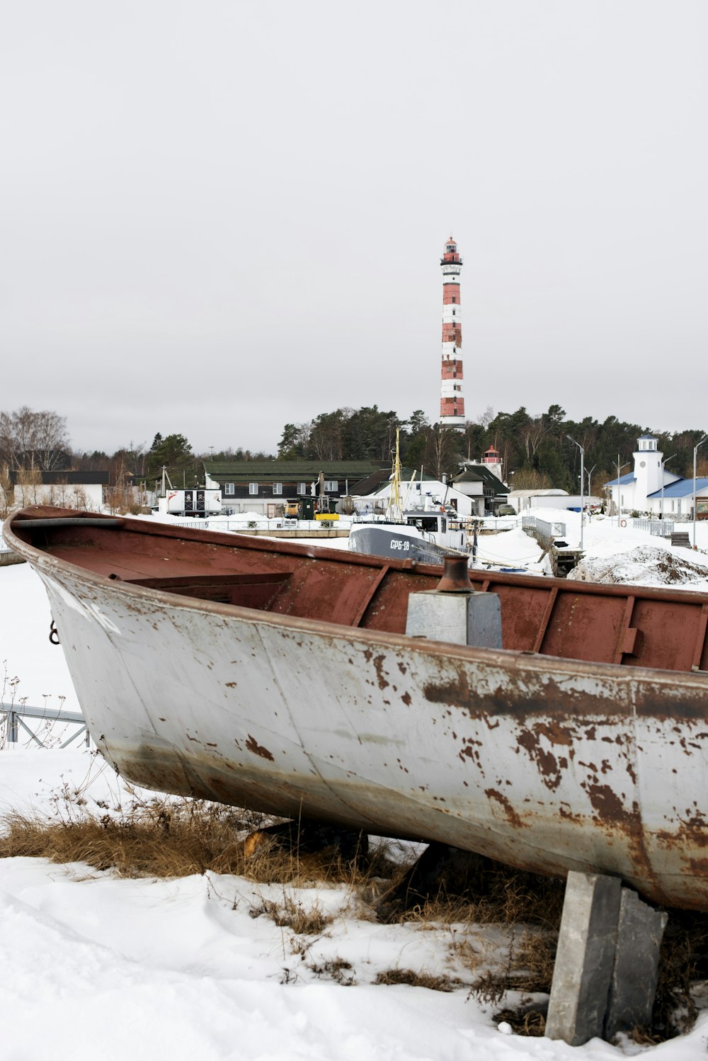 a boat sitting on top of snow covered ground