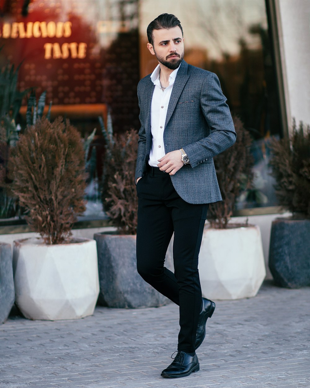 a man in a suit is standing outside