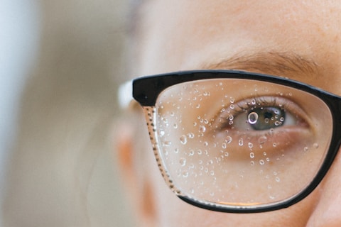 a close up of a person wearing glasses
