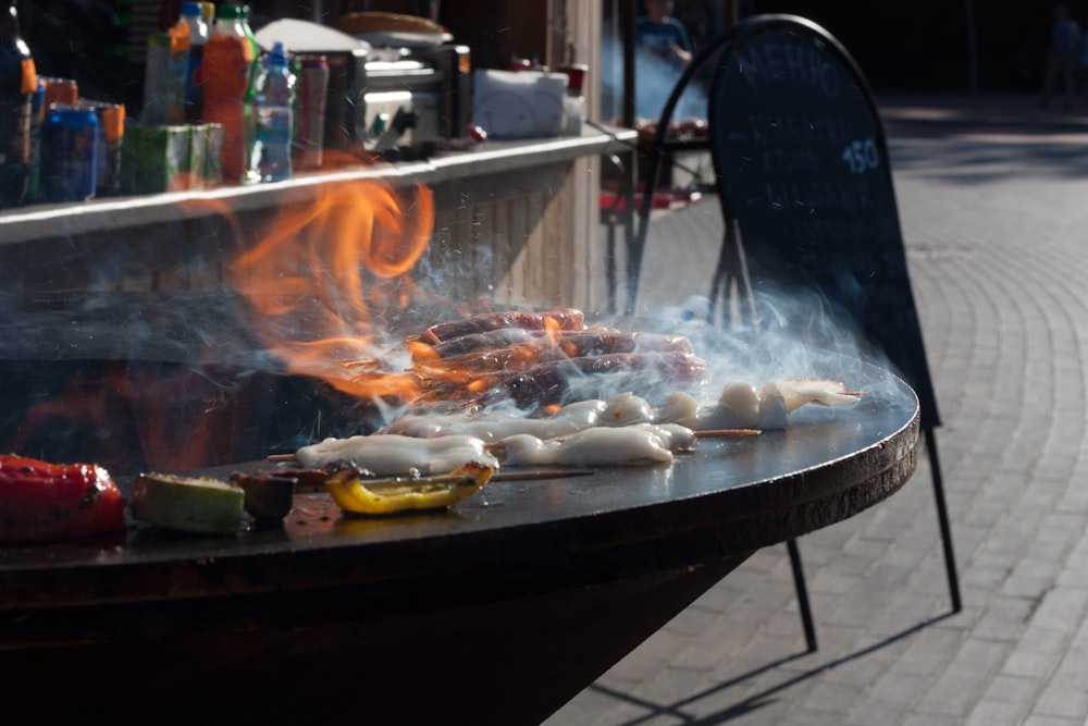 a bbq grill with a lot of food cooking on it