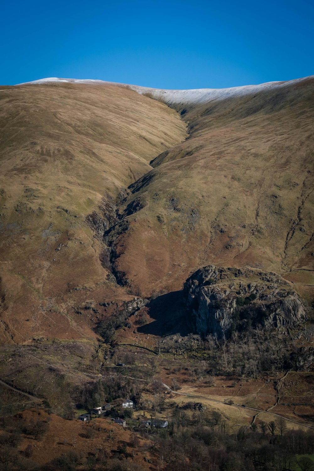 a view of a mountain with a small stream running through it