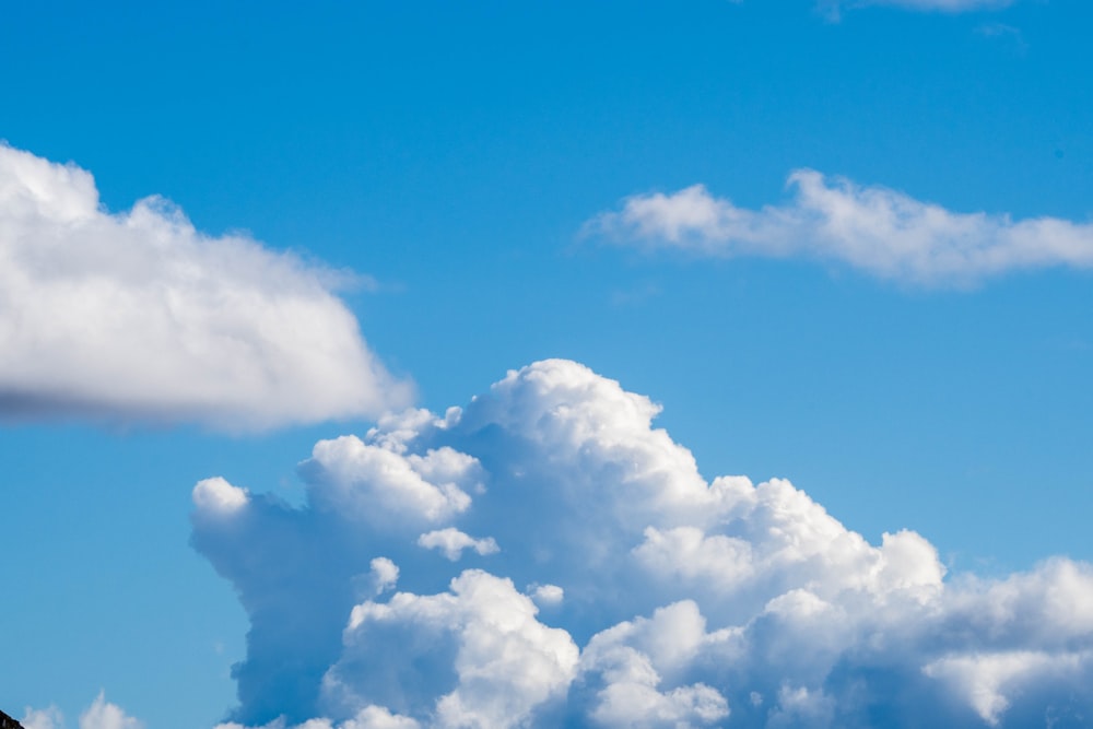 a plane flying in the sky with a lot of clouds