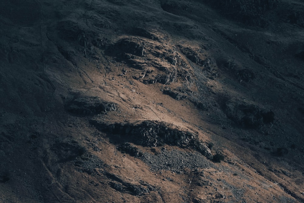 a close up of a mountain side with rocks and dirt