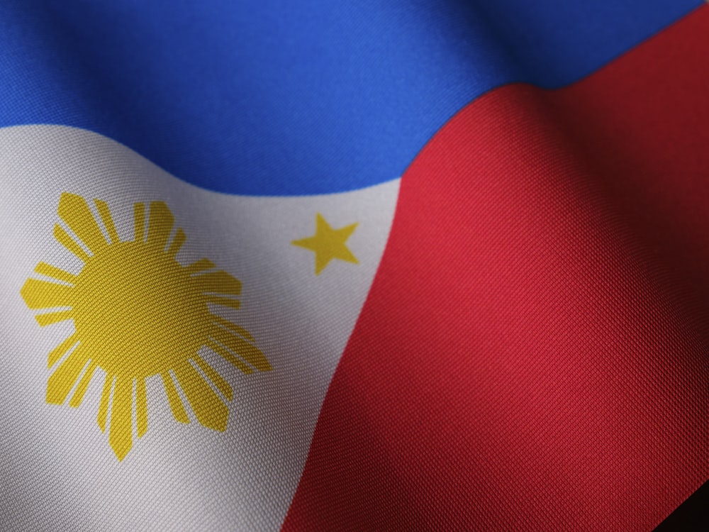 the flag of the philippines is waving in the wind