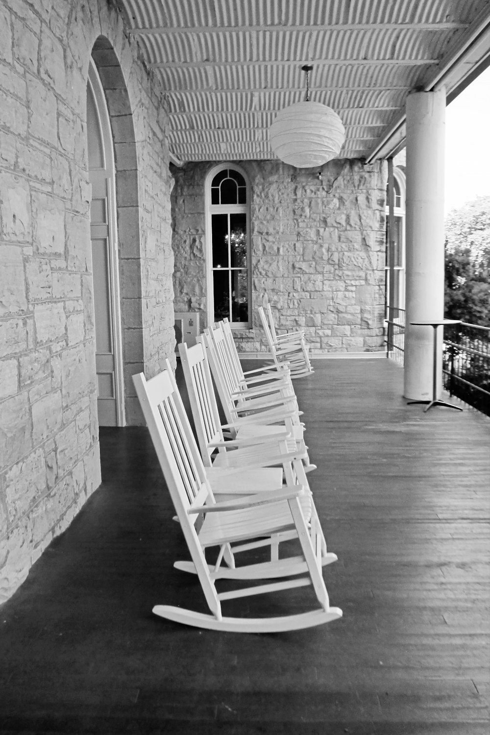 a row of rocking chairs sitting on top of a wooden floor