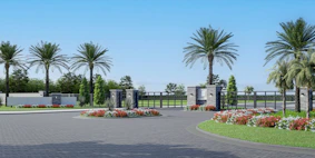a driveway with a gate and flowers in the middle of it