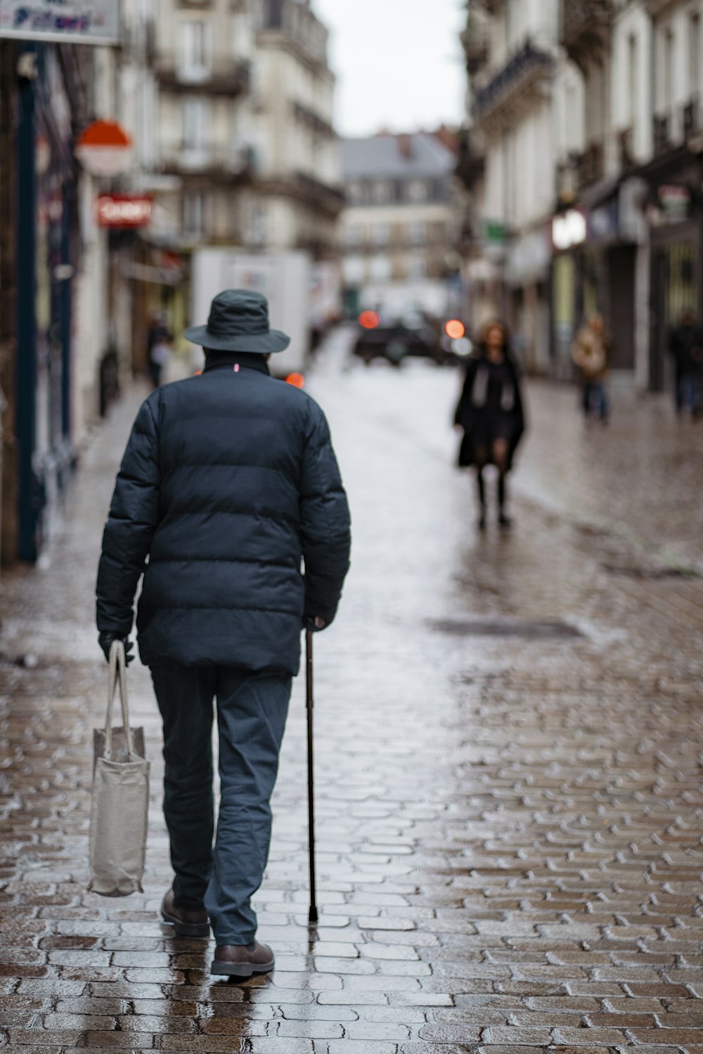 a man walking down a street holding an umbrella