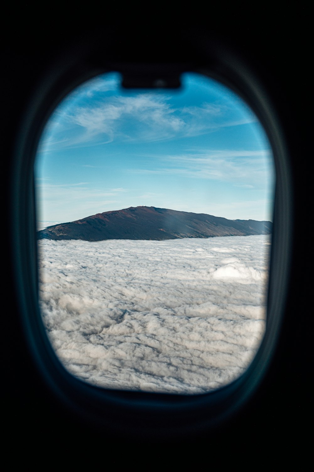 a view of a mountain from an airplane window