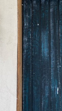 A close-up of a textured drywall panel painted in a rich, bold color.