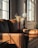 A clean and bright living room with sunlight streaming through the windows, showcasing a fresh and inviting atmosphere.
