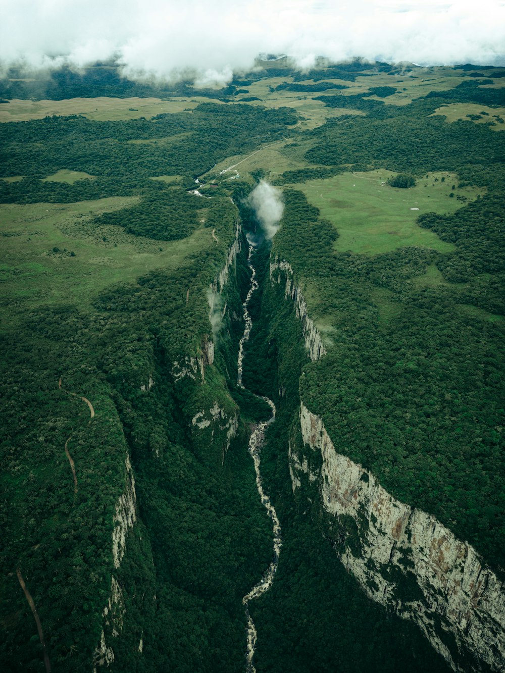 an aerial view of a mountain with a river running through it