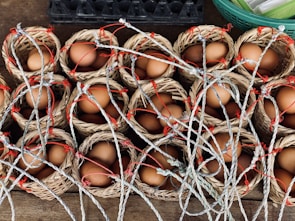 Freshly laid eggs neatly arranged in rustic baskets ready for delivery.