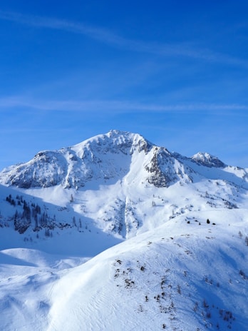 A sleek, icy mountain range under a clear blue sky, symbolizing strength and clarity.